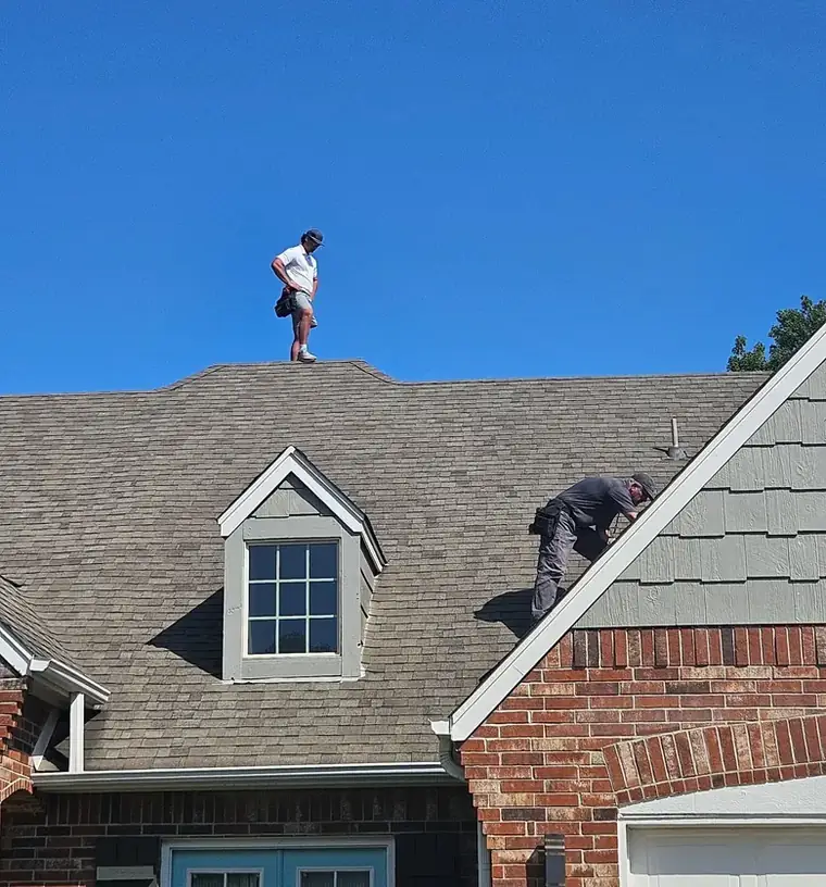 Two of the crew working a steep dormer slope in Bartlesville — Bartlesville Roofing & Gutters, Bartlesville OK